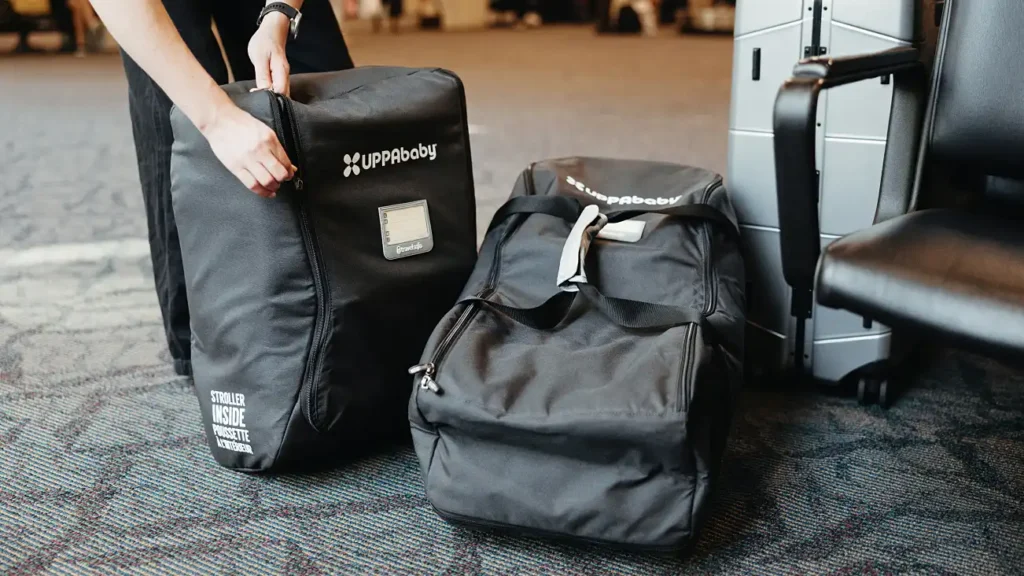 Car seats packed securely in their travel bags in an airport