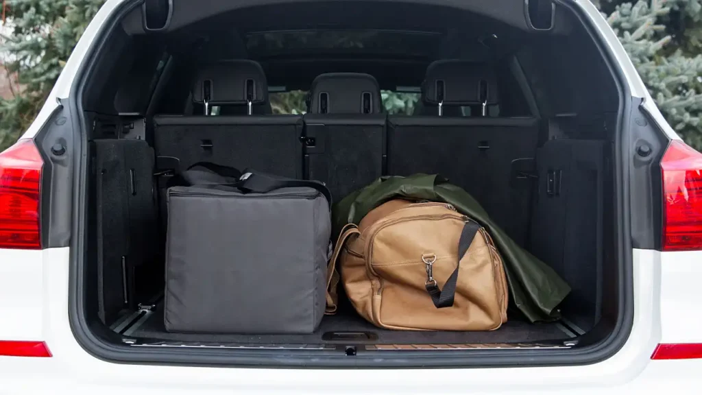 A stroller packed in a travel bag and stored with other luggage in a trunk